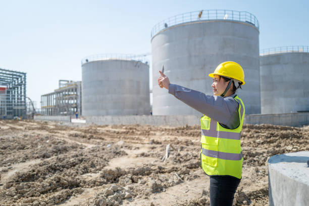 istock An Asian female worker took pictures on an unfinished construction site with a tablet computer. 1397433379