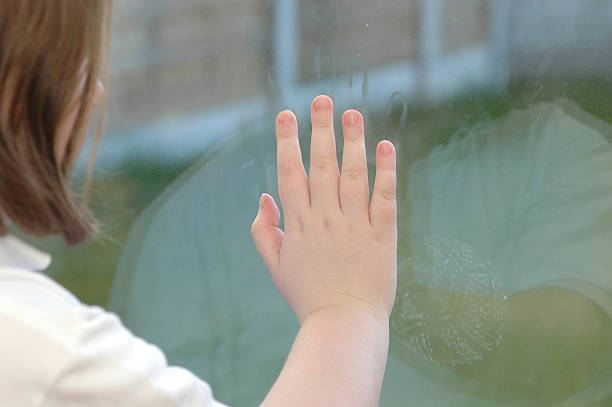 istock girl behind pane 139743385