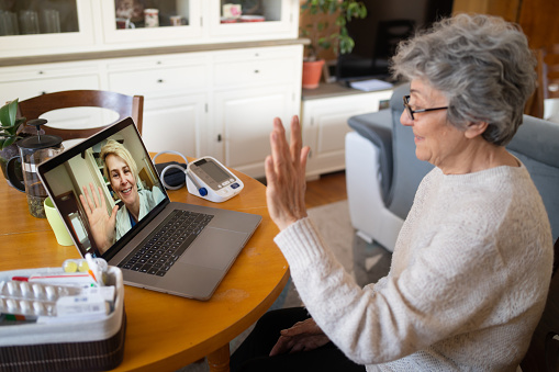 Older woman having online consultation with her doctor on a video call.