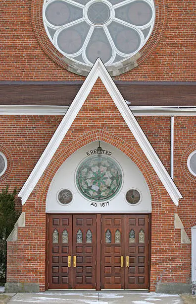 old brick church with wooden doors