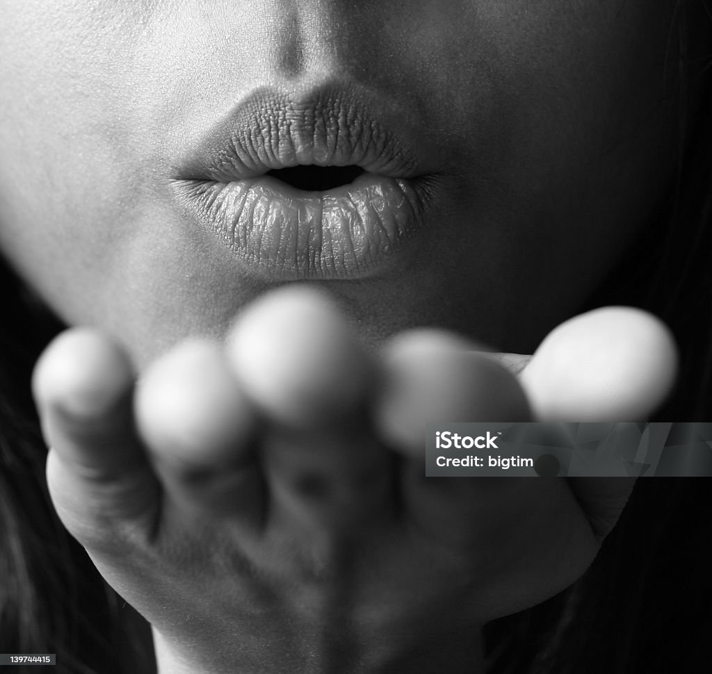 Blowing a kiss Close up of a girl blowing a kiss, with shallow DOF and focus on her lips Adult Stock Photo