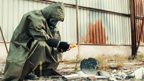 istock man with geiger counter near radioactive barrels 1397444395