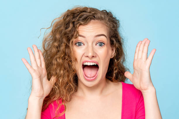 istock Ecstatic Caucasian woman screaming with open hands in isolated light blue color studio background 1397444522