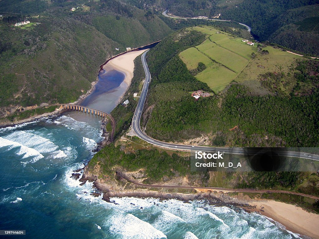 Aerial view of coastline Aerial view of a coastline and winding road. Africa Stock Photo