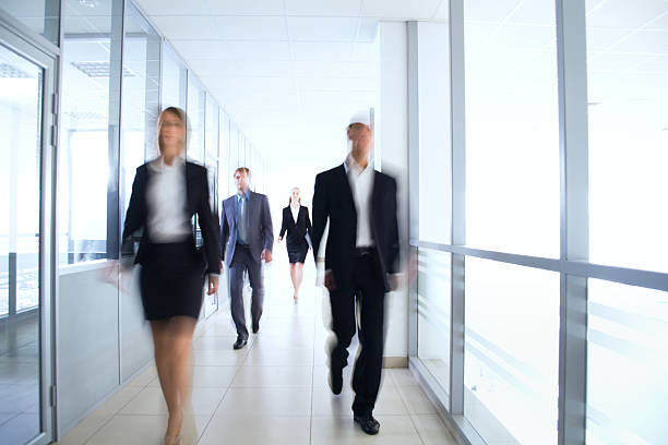 istock Blurred businesspeople walking down a corridor 139745028