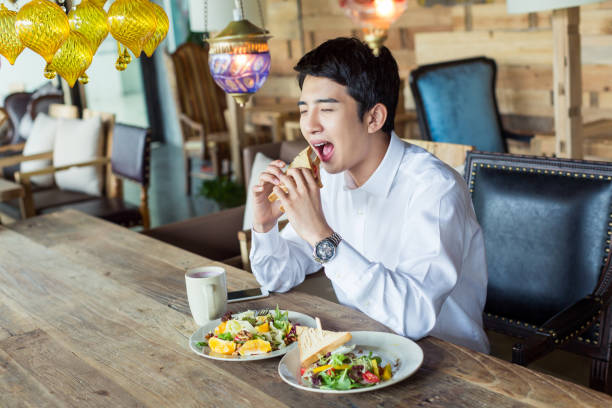 west restaurant young people young handsome businessman wearing a white shirt in the restaurant chinese ethnicity china restaurant eating stock pictures, royalty-free photos & images