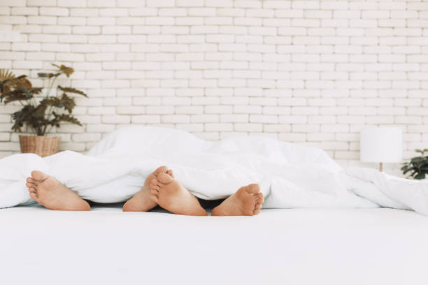 lgbt couple sleeping in bed together. - sex education condom contraceptive sex imagens e fotografias de stock