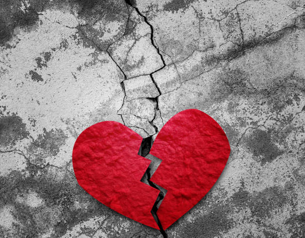 istock Broken red paper heart on the floor. 1397454067