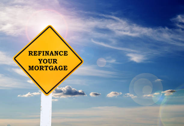 istock Text for Refinance your mortgage on yellow road sign 1397454141