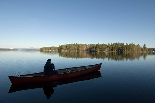 Man in a Canoe on the Lake stock photo