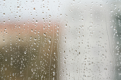 Raindrops on a window pane during rainy weather