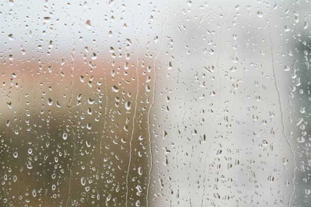 Raindrops on a window pane stock photo