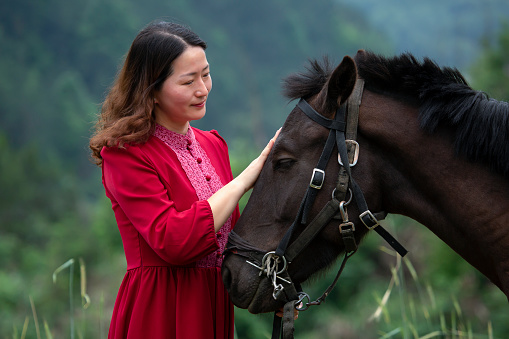 An Asian woman and her horse