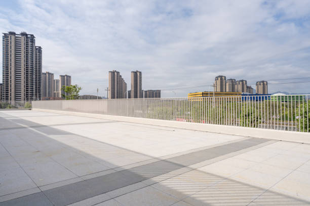 istock An empty stone square and the city skyline in the distance 1397459768