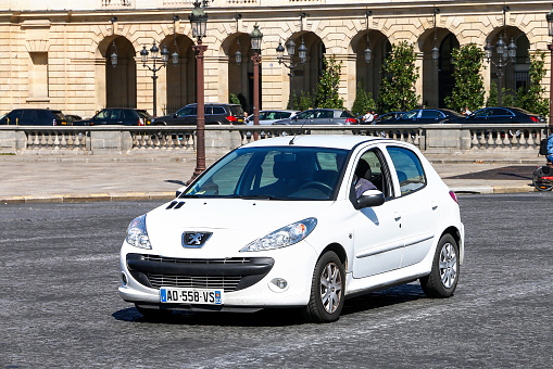 Paris, France - September 15,2019: White urban hatchback Peugeot 206+ in a city street.