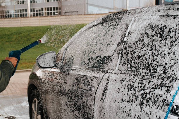 istock Washing black car with high pressure foam. Close-up, selective focus 1397463415