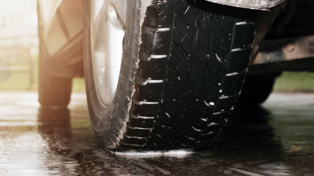istock Car wash, vehicle cleaning outdoors. Close-up wet wheel low angle view. Selective focus 1397463433