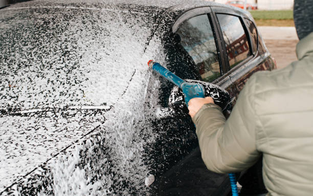 istock Self-service car wash, caring for black car using high-pressure foam shampoo. Close-up, selective focus 1397463441