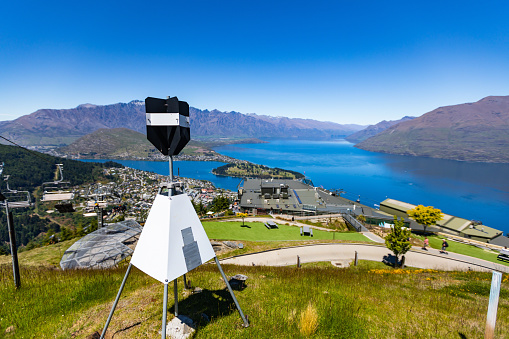 This 28 November 2021 photo shows a trig beacon above Tāhuna Queenstown, Aotearoa New Zealand. The geographical survey tool belongs to Toitū Te Whenua Land Information New Zealand (LINZ). The marker has a clear view across Lake Wakatipu toward Tākitimu the Remarkables.