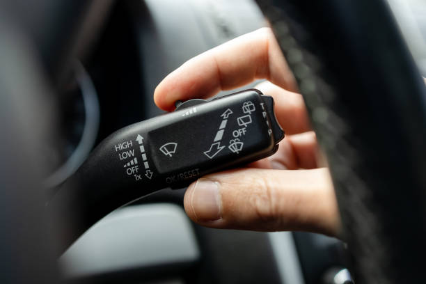 istock male person adjusting car wipers speed. car wiper switch handle macro close up. windshield wipers speed control wheel. car interior 1397464565