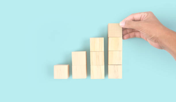 istock Business connecting piece of multi wood chart blocks steps in hand 1397465254