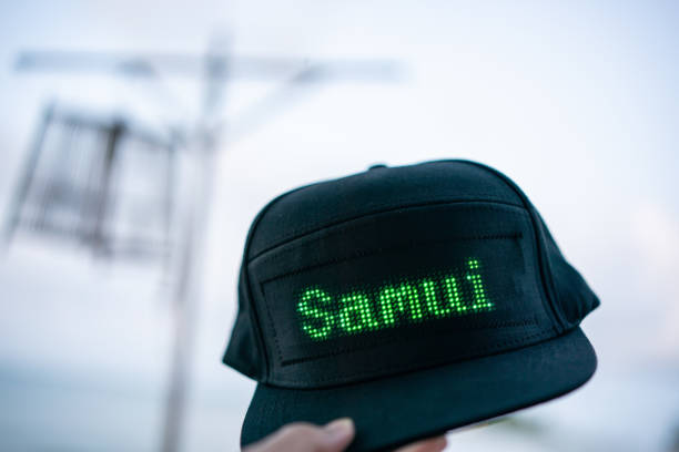 istock Hand holding black baseball cap with LED letter 