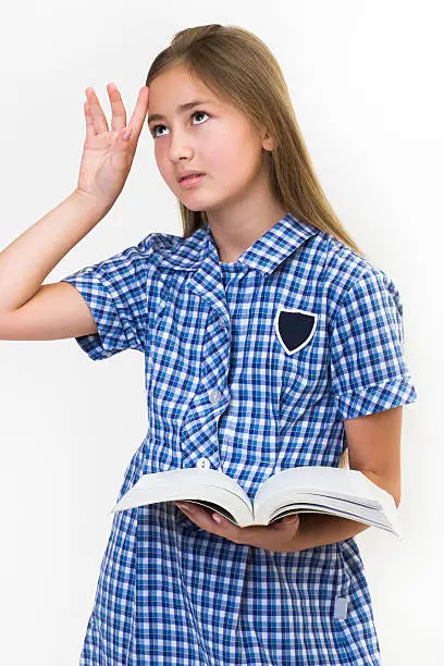 School girl fed up with reading her book