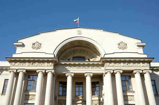 Kazan, Russia, May 2022: National Bank of the Republic of Tatarstan on Bauman Street in Kazan. The flag of Russia flutters on the roof of the bank.