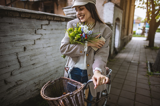 Photo of young woman doing her chores on the bicycle around the city