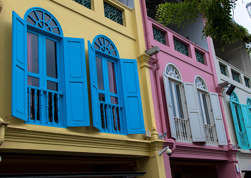 Colorful building with multicolored shutters next to the waterfront in downtown Singapore.