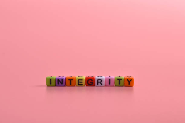 istock Alphabet beads with text INTEGRITY isolated on pink background 1397467849