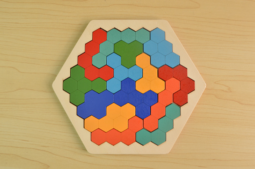 Colorful wooden hexagon on the table. Top view.