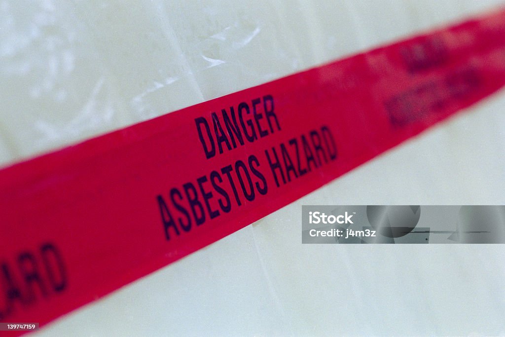 Asbestos Tape Asbestos tape accross plastic containment area. Asbestos Stock Photo