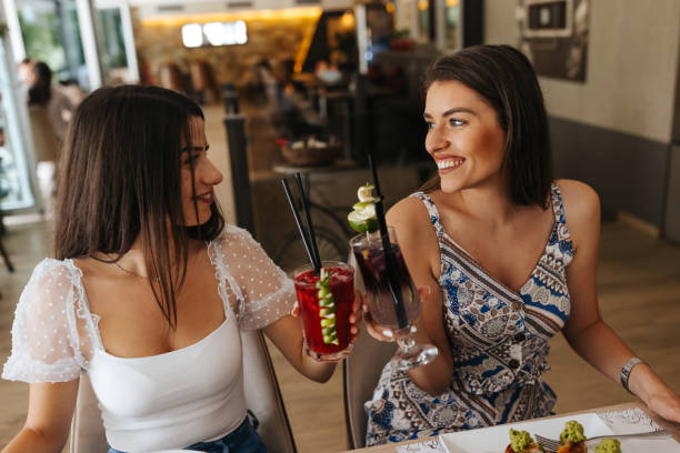 istock Female friends toasting at restaurant 1397471909
