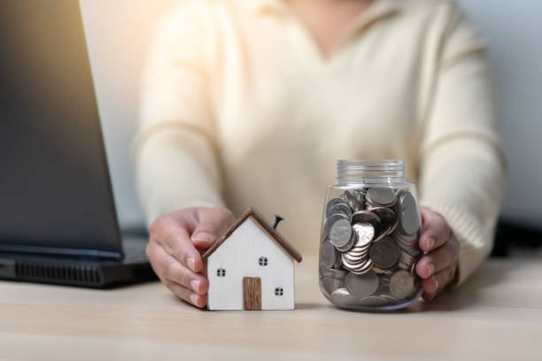 istock Working woman save money for a new house. 1397473050