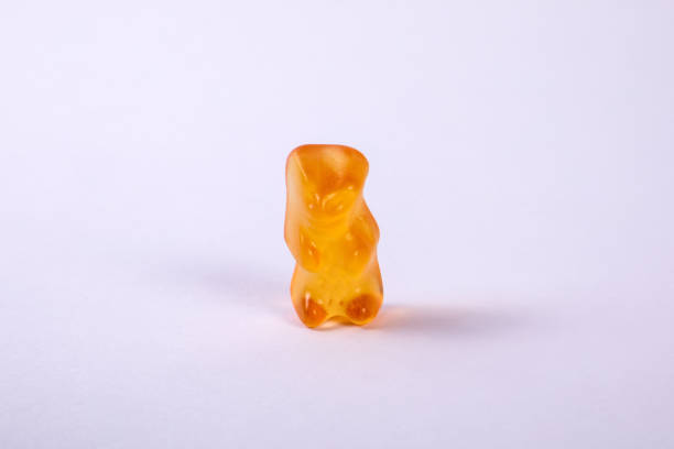 istock Orange rubber bear on a white background. Sweets and unhealthy diet 1397473131