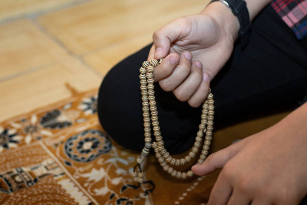 istock Religious muslim boy praying inside the mosque, muslim boy praying with beats 1397473882