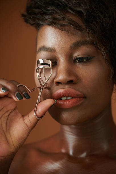 istock Black Woman Curling Lashes 1397474303