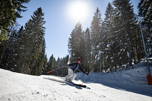 Mayrhofen, Austria - February 4, 2019: Man Skier at mountains in Zillertal Arena ski resort Zillertal in Tyrol. Mayrhofen in Austria in winter in Alps. Person at Alpine mounts with snow. Blue sky