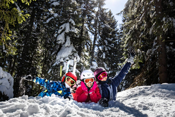 istock Three little skier lying on front and looking at camera 1397474945