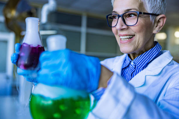istock Happy senior chemist working with chemical substances in laboratory. 1397475233