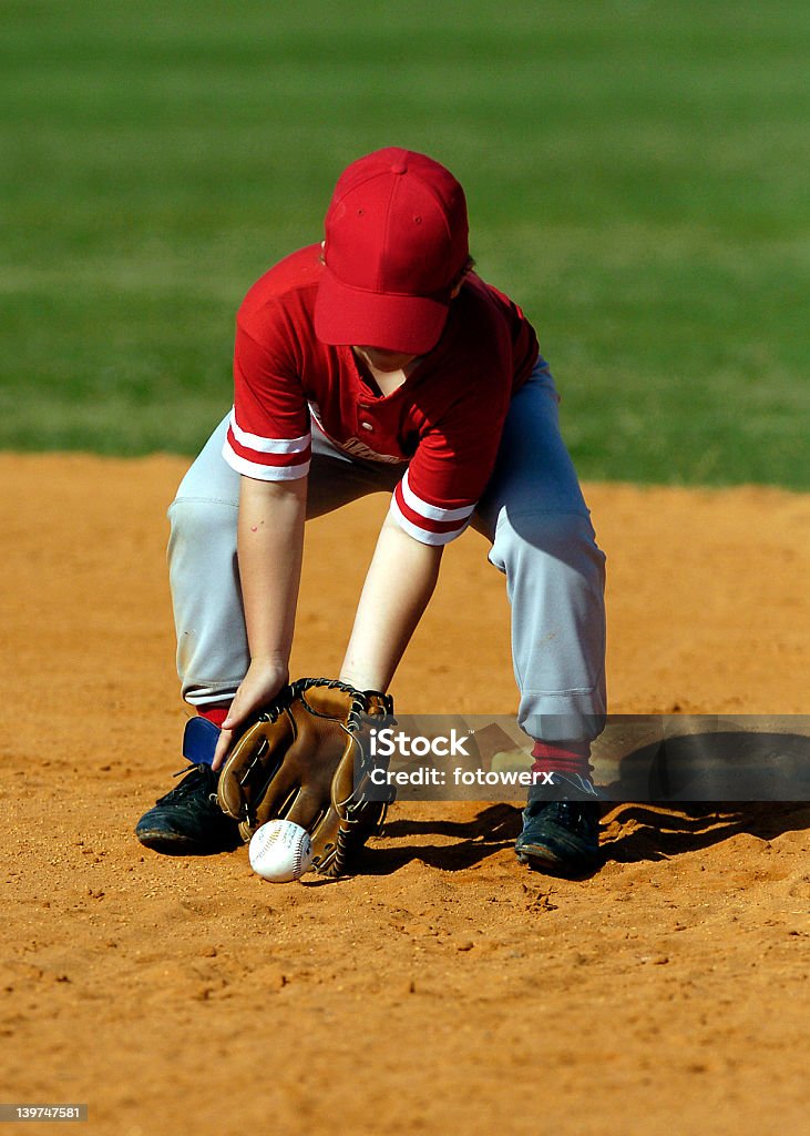 baseball player scoops up ball young boy baseball player scoops up ball Baseball - Ball Stock Photo