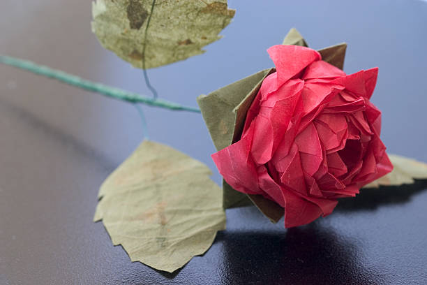 Origami rose on black table stock photo