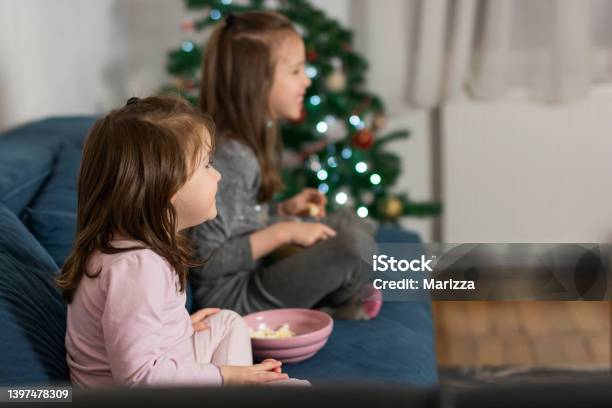 Children Eating Popcorn And Wathcing Movie Stock Photo - Download Image Now - Watching TV, Christmas, Movie