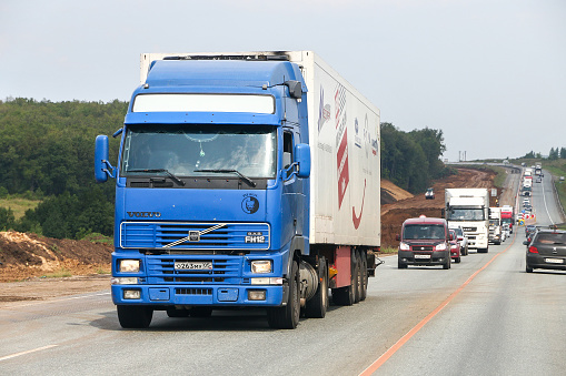 Bashkortostan, Russia - August 4, 2020: Blue semitrailer truck Volvo FH12 at an intercity road.