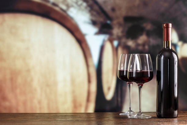 istock Wine cellar with wine bottle and glasses. Red wine tasting in the wine cellar. 1397479264