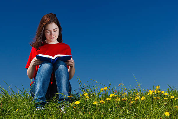 istock Girl reading book outdoor 139747962
