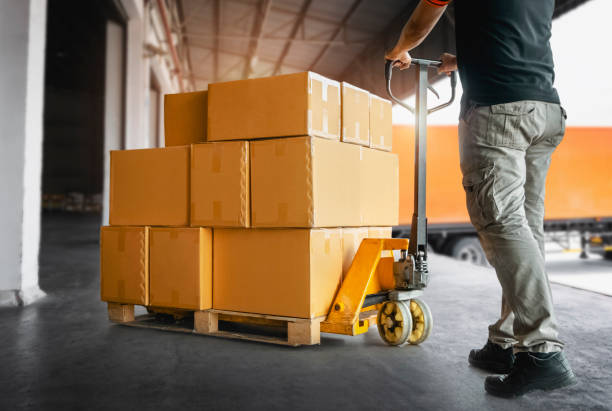 istock Workers Unloading Packaging Boxes on Pallets to The Warehouse. Cartons Cardboard Boxes. Shipping Warehouse. Delivery. Shipment Goods. Supply Chain. Warehouse Logistics Cargo Transport. 1397480714