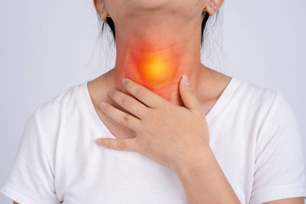 Woman with pain in the throat on a white background She has tonsils. Woman with pain in the throat on a white background She has tonsils. larynx stock pictures, royalty-free photos & images