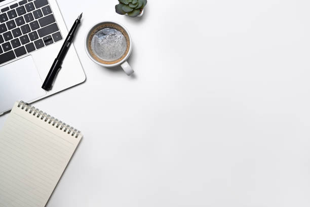 istock Minimal workplace with laptop computer, coffee cup, notepad and potted plant. Flat lay, Top view with copy space. 1397481009